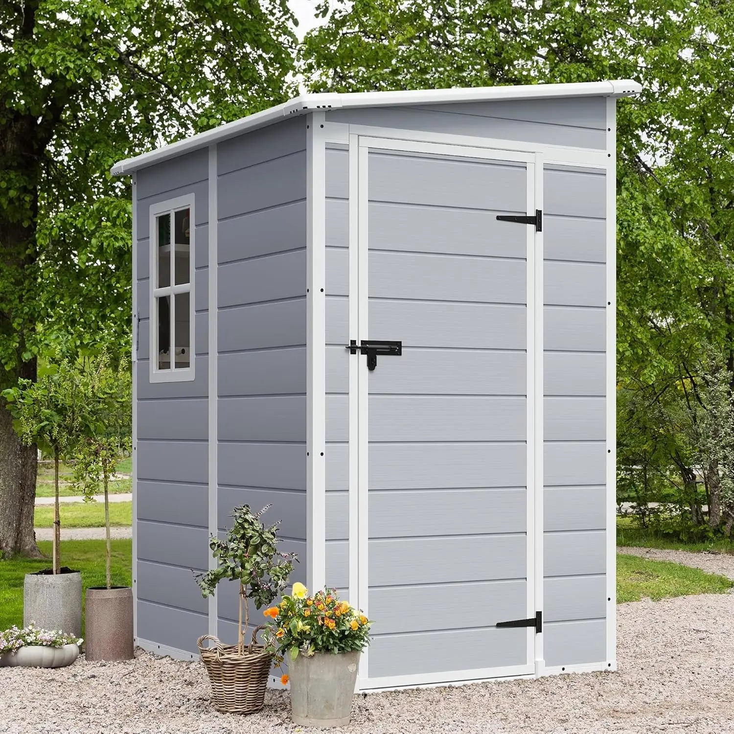 Outdoor 5x4 FT resin storage shed with lockable door and heavy-duty floor in backyard setting
