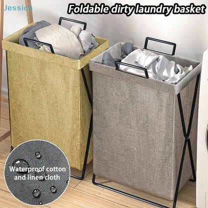 Collapsible fabric laundry hamper with handles in bedroom setting